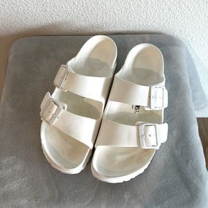 White plastic sandals in size 6.5